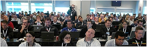 Conference goers look towards stage.