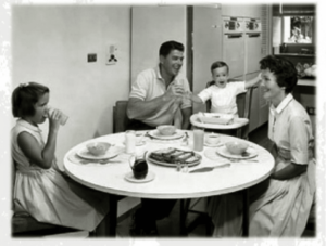 A image of Reagan sitting with his family at supper to condition the people to see him as a family man.