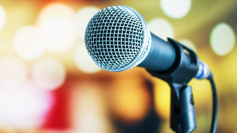 Microphone against a blurred background to introduce, Pubcon Workshops: It's All About The Audience, Marketers