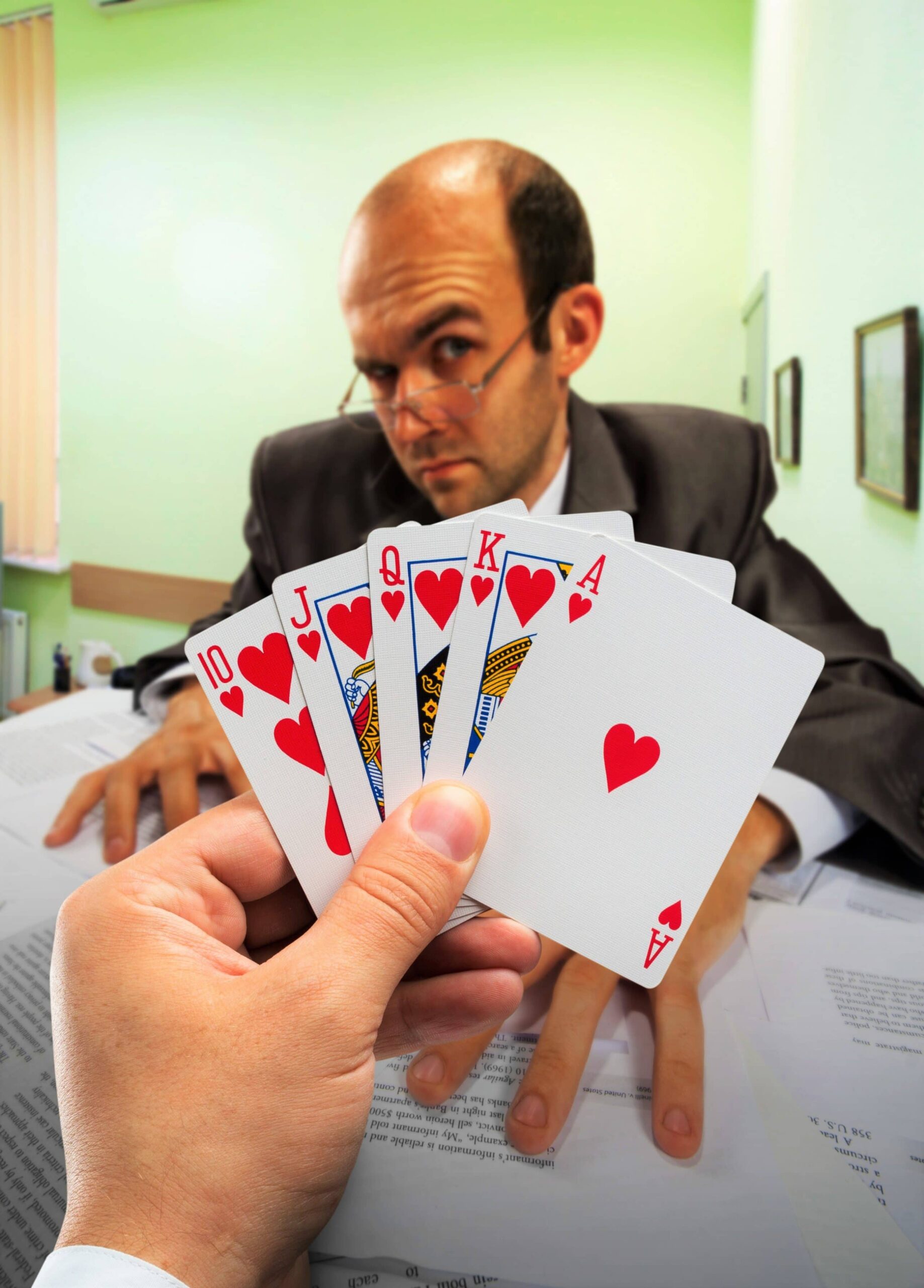 Businessmen playing poker at office