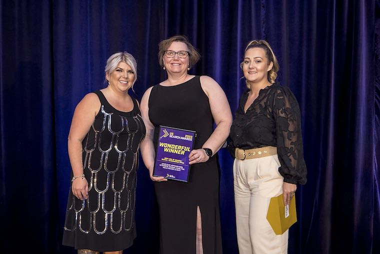 Amanda Farley and Laura Weintraub receive a US Search Award from Don't Panic's Helen Barkley.